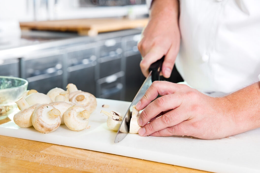 professional-chef-cutting-mushrooms-in-the-kithcen-2025-03-11-16-26-48-utc